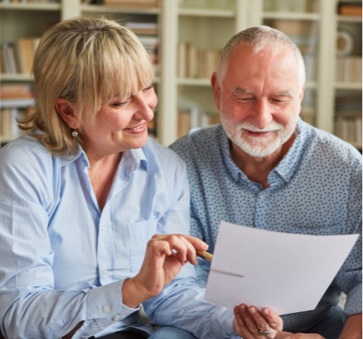Senior Man Getting Assistance From Woman on Taxes