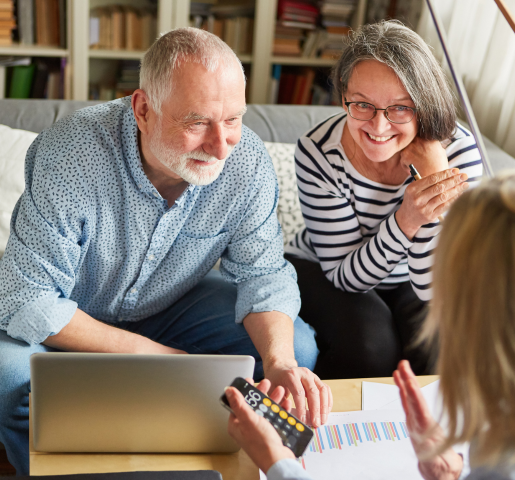Two Older Adults Looking At A Computer